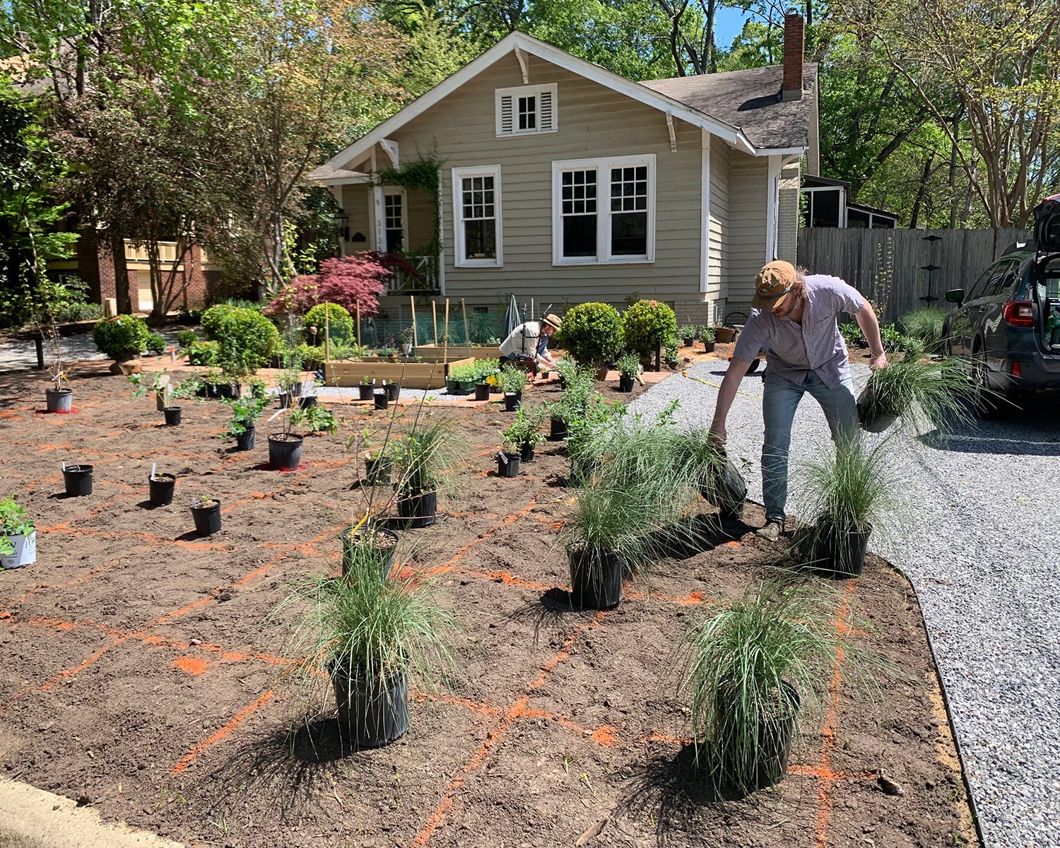 people planting in front yard