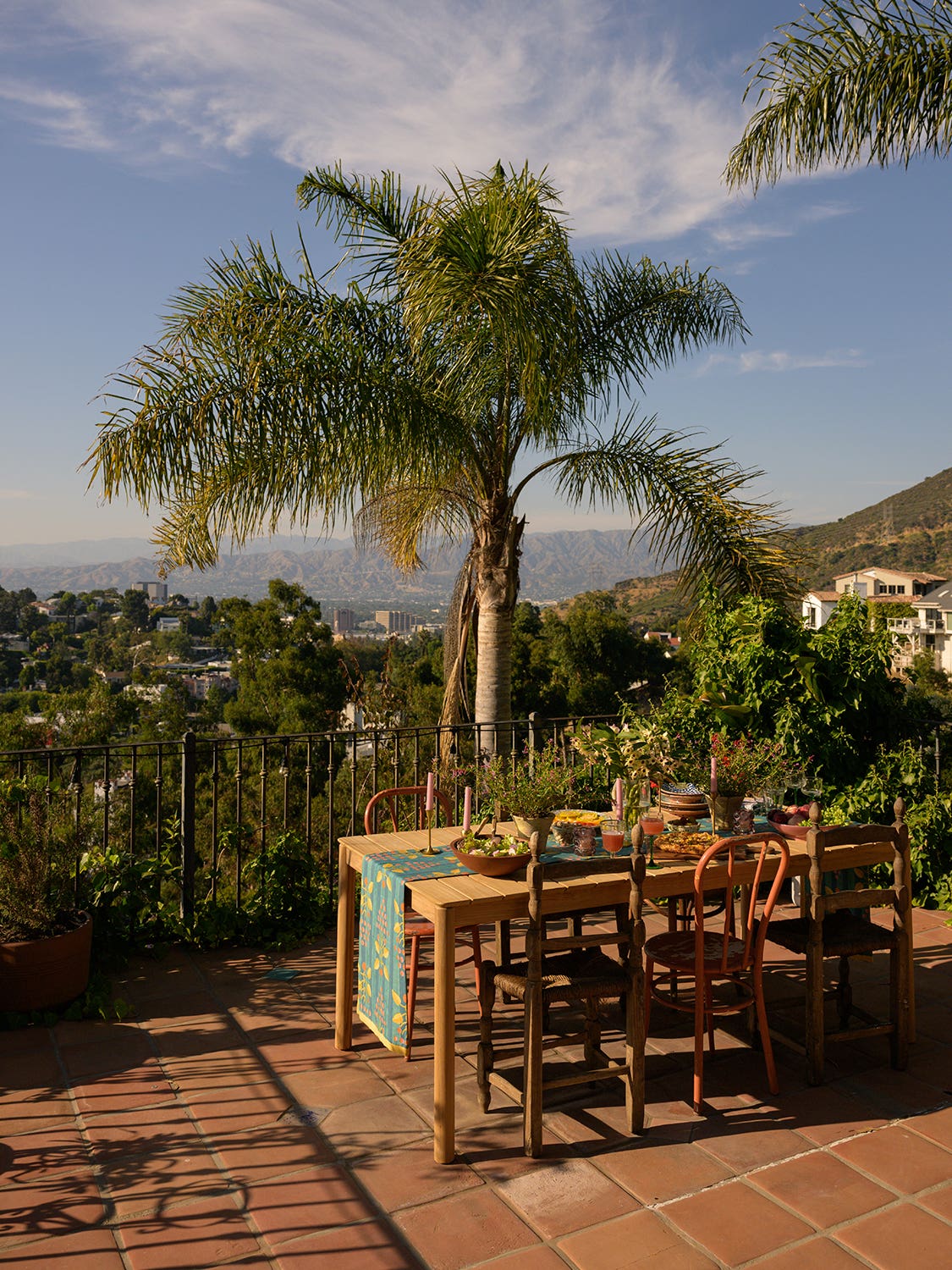 Table on a patio overlooking Los Angeles and palm trees