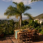Table on a patio overlooking Los Angeles and palm trees