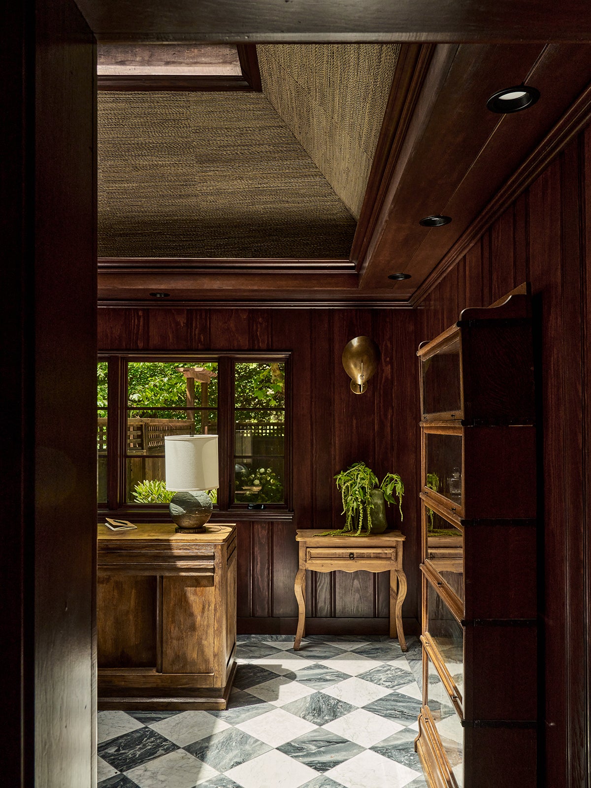Spa entrance with wood walls and marble checkerboard floors