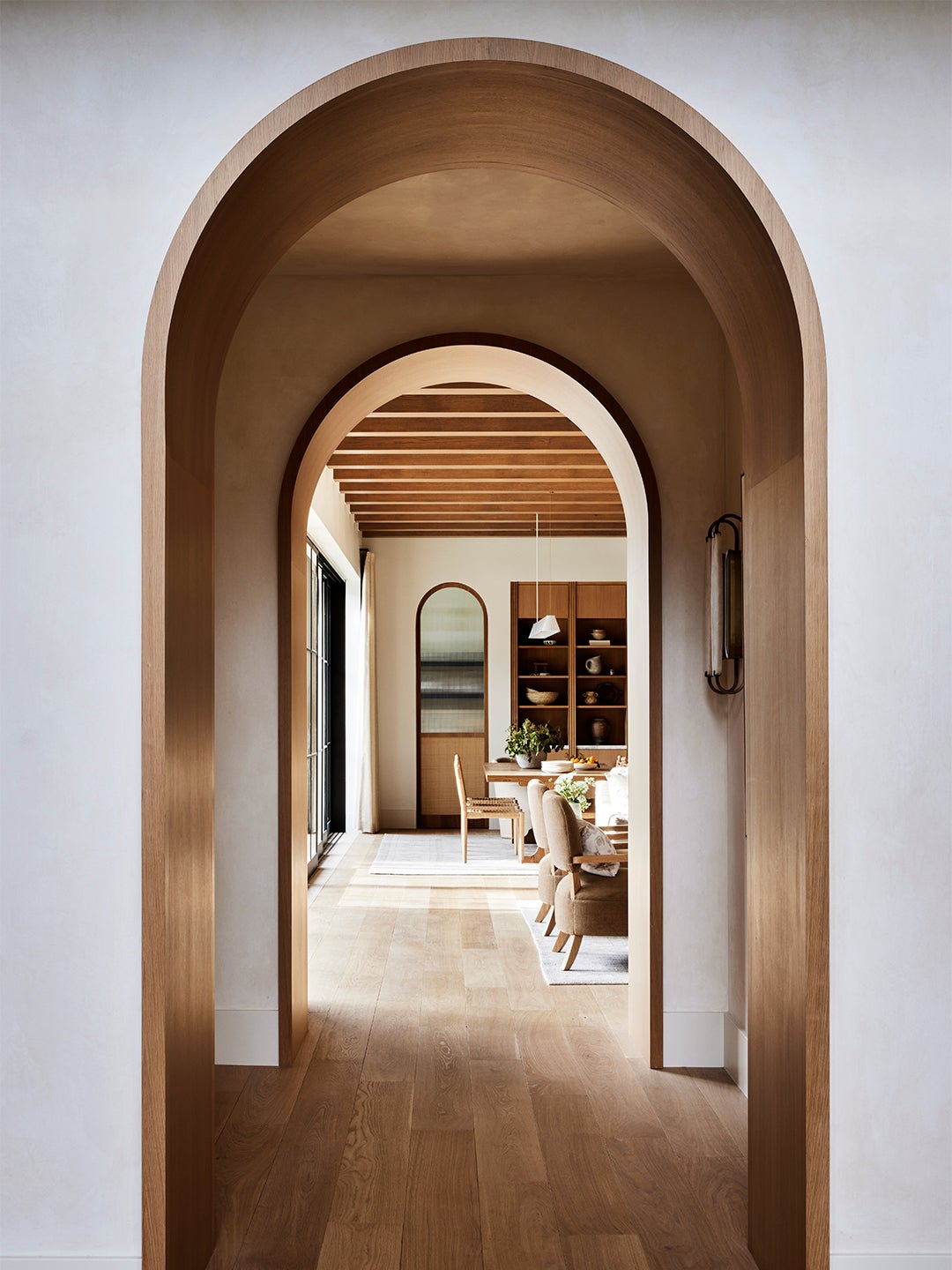 Arched hallway looking into dining room