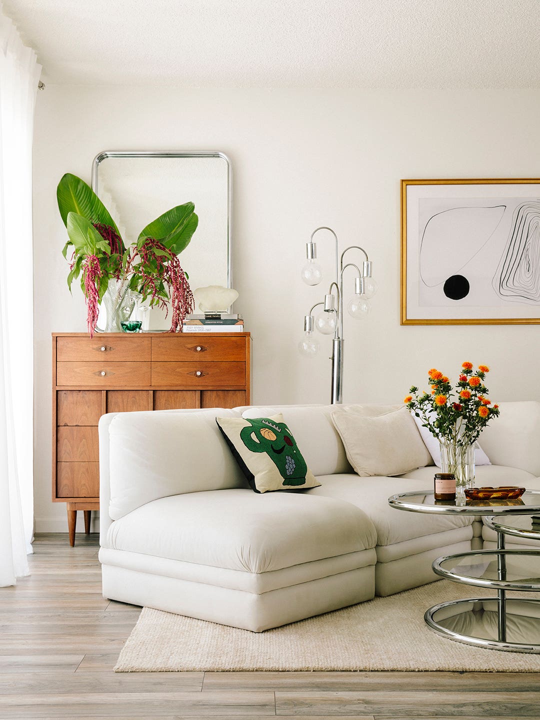 Living room with white sofa and midcentury console