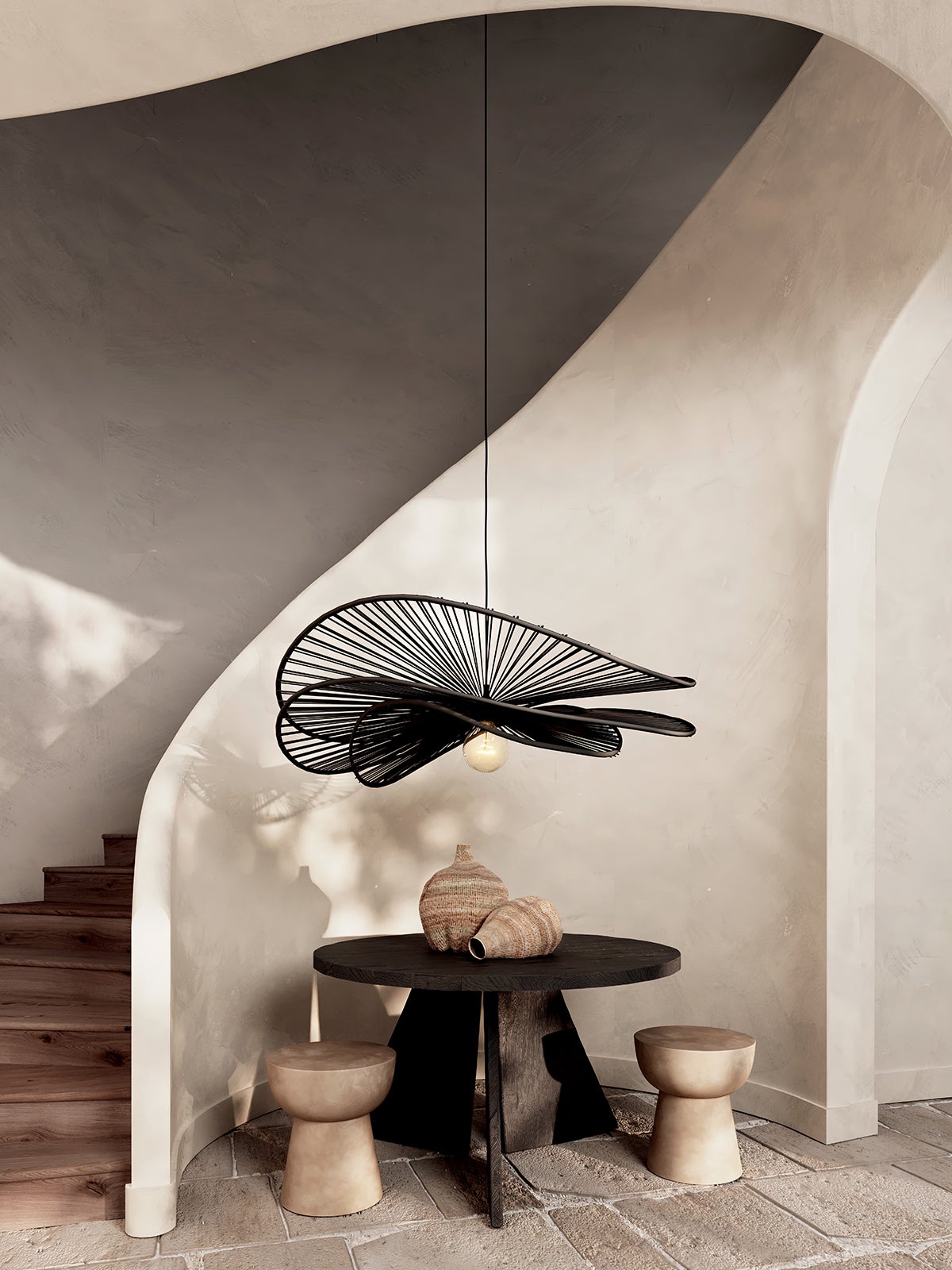 Black lamp suspended over table