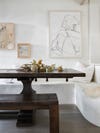 large wooden table with white plastered bench
