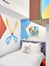 Kids bed with striped headboard and wall mural art.