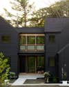Modern house in nature painted black.