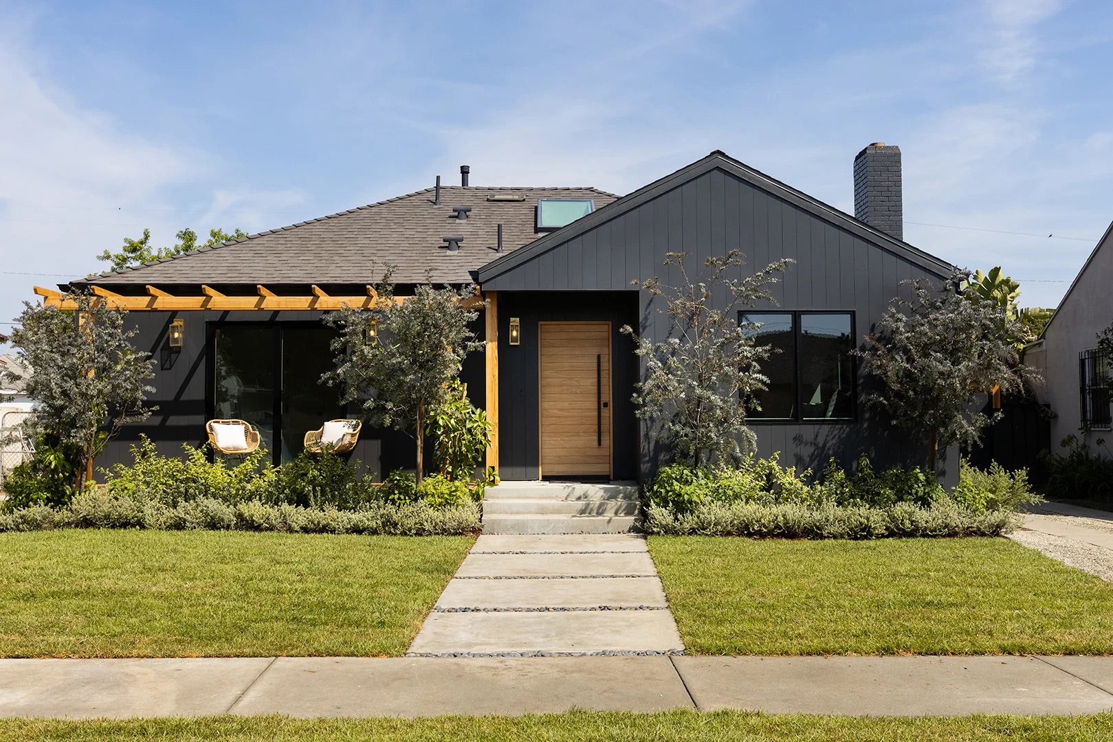 Black painted bungalow exterior with wood accents.