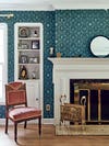 Fireplace against a wallpapered wall