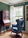 Chair and desk in wallpapered room