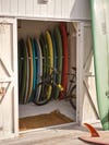 Lineup of surfboards in a closet