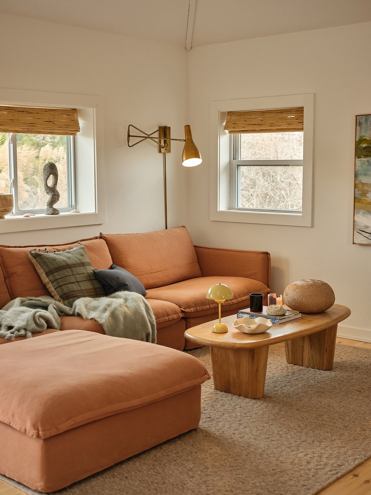 Terracotta-colored L shaped sofa in a small living room