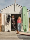Man and woman with surfboards