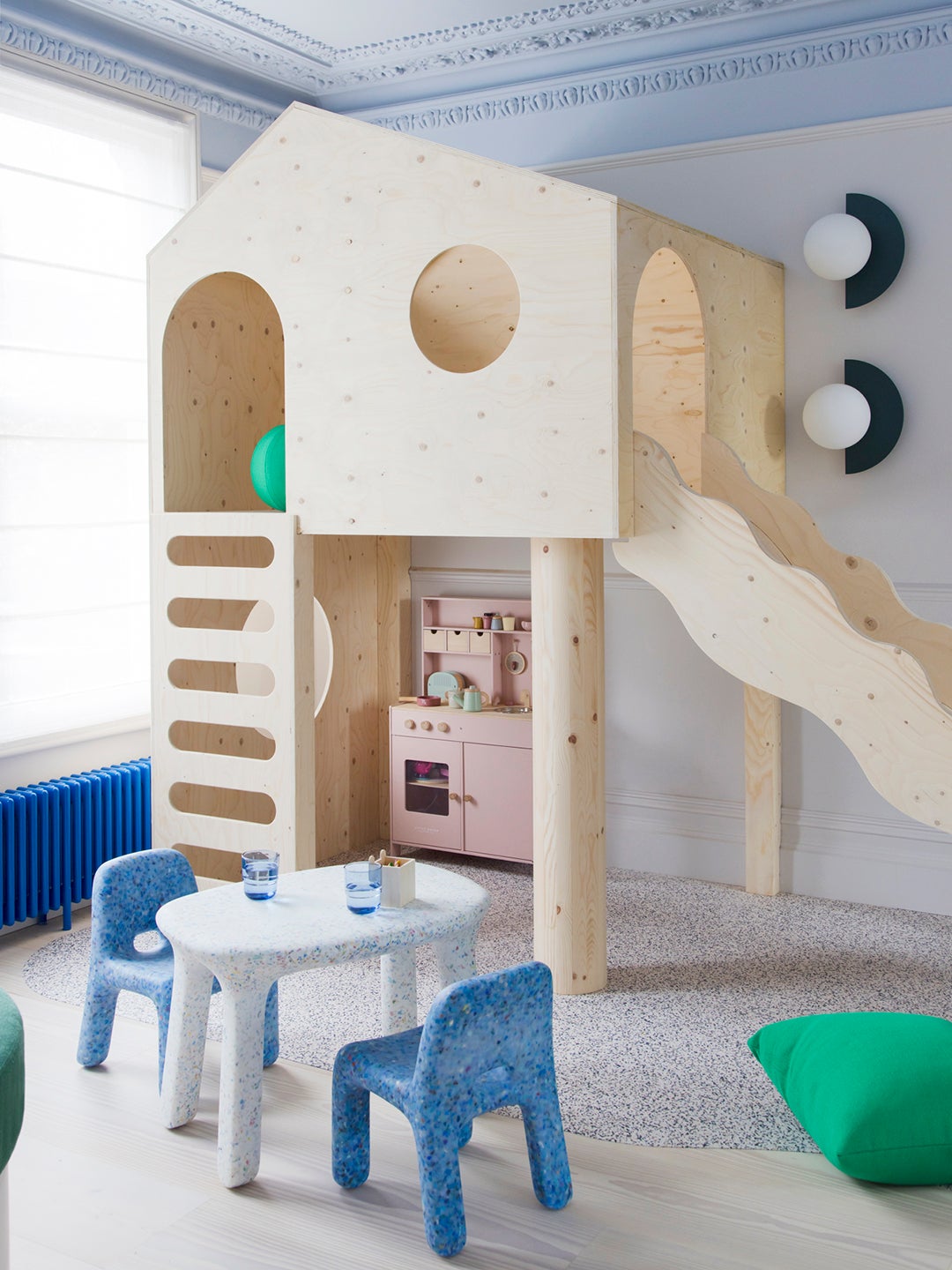 Birch wood play structure with slide in kids' playroom.