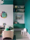 Kid's bedroom with green accent walls.