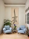 Room with alligator tapestry and two blue accent chairs