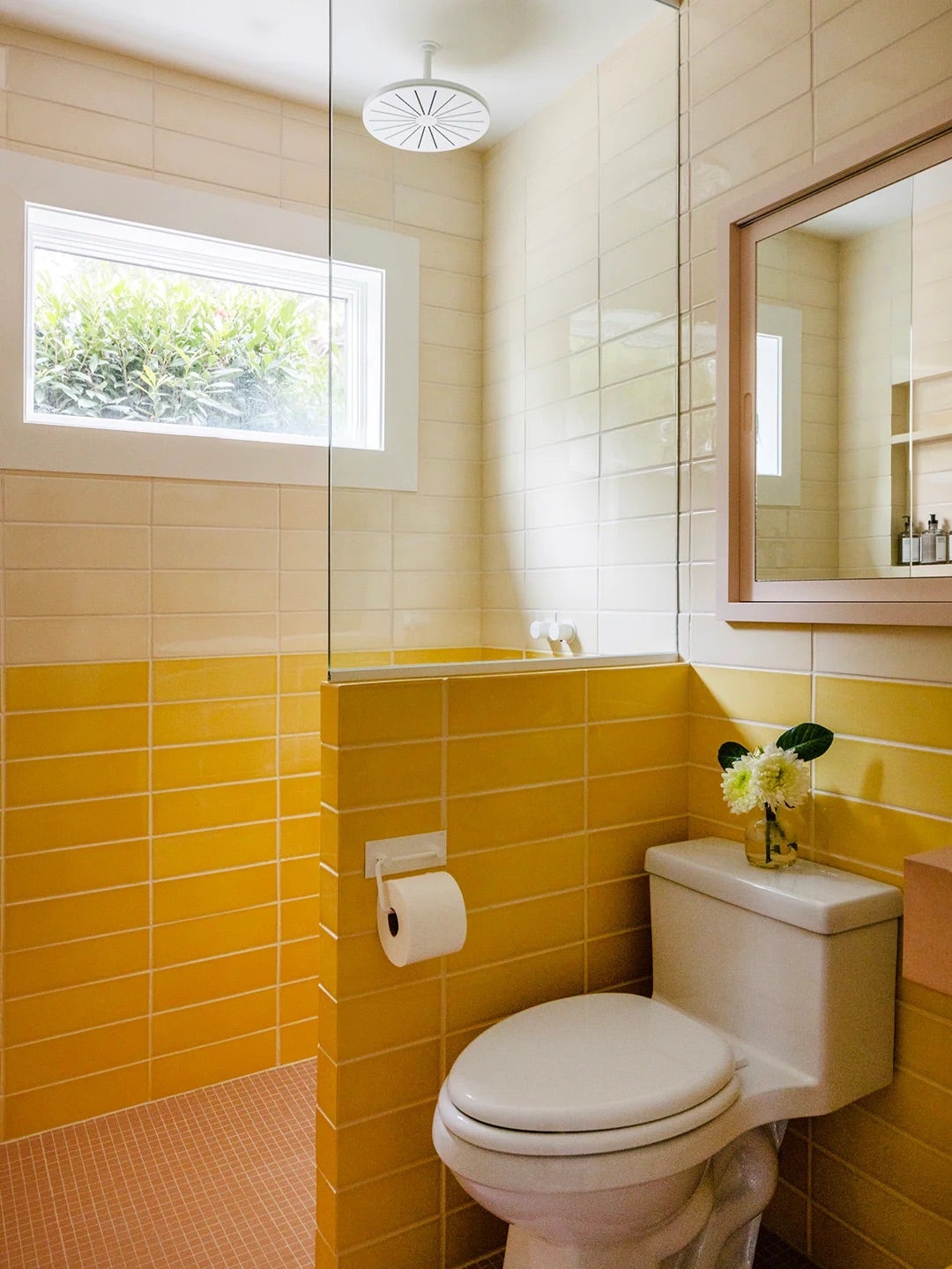 Sunny bathroom with two shades of yellow tiles. 