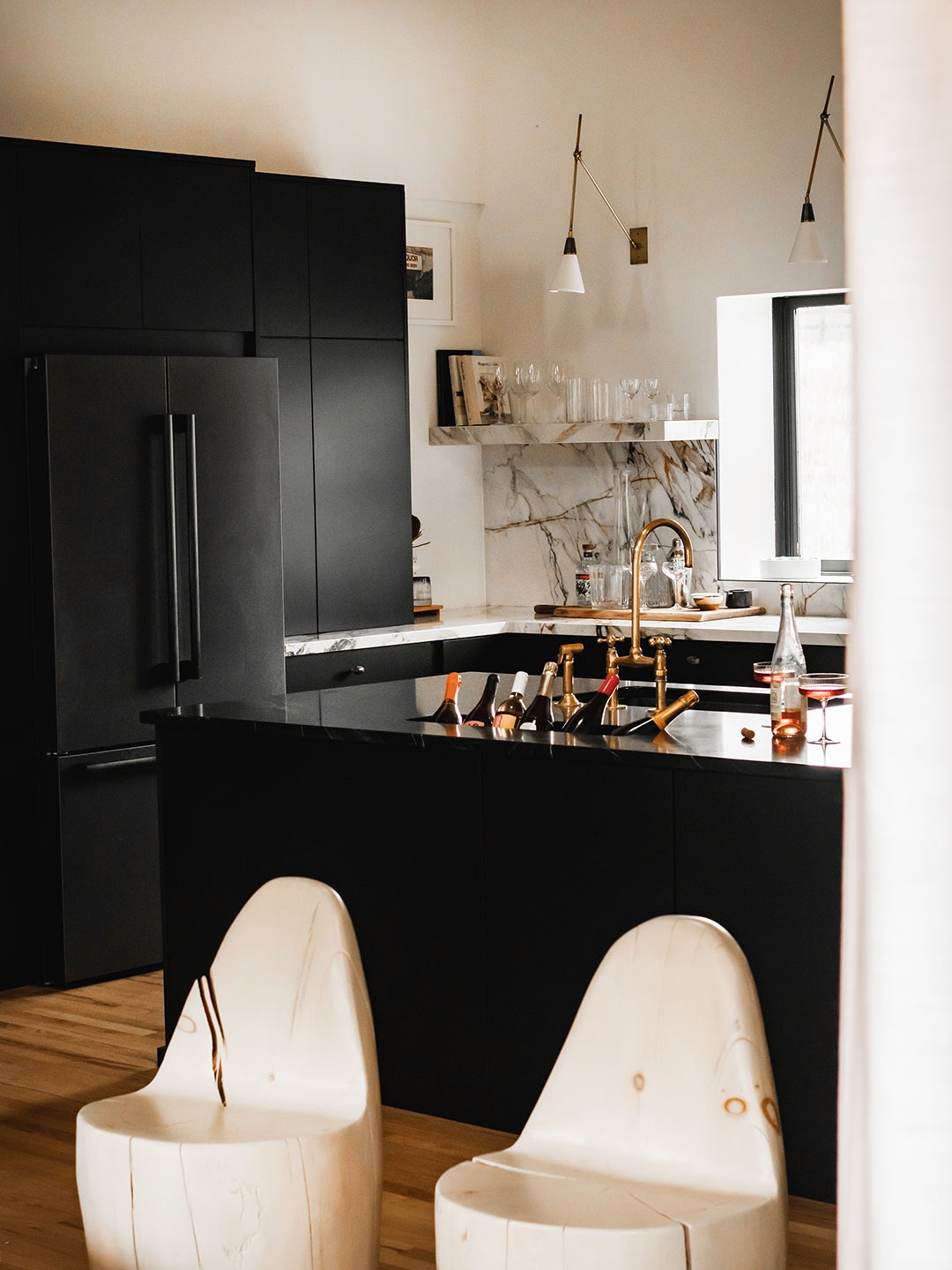 Kitchen with black counters and champagne sink