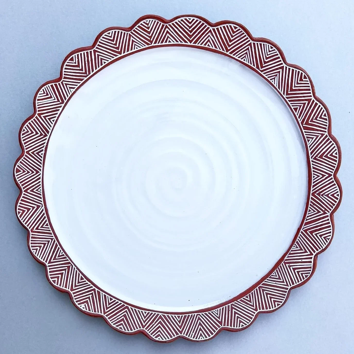 Serving platter with red patterned rim