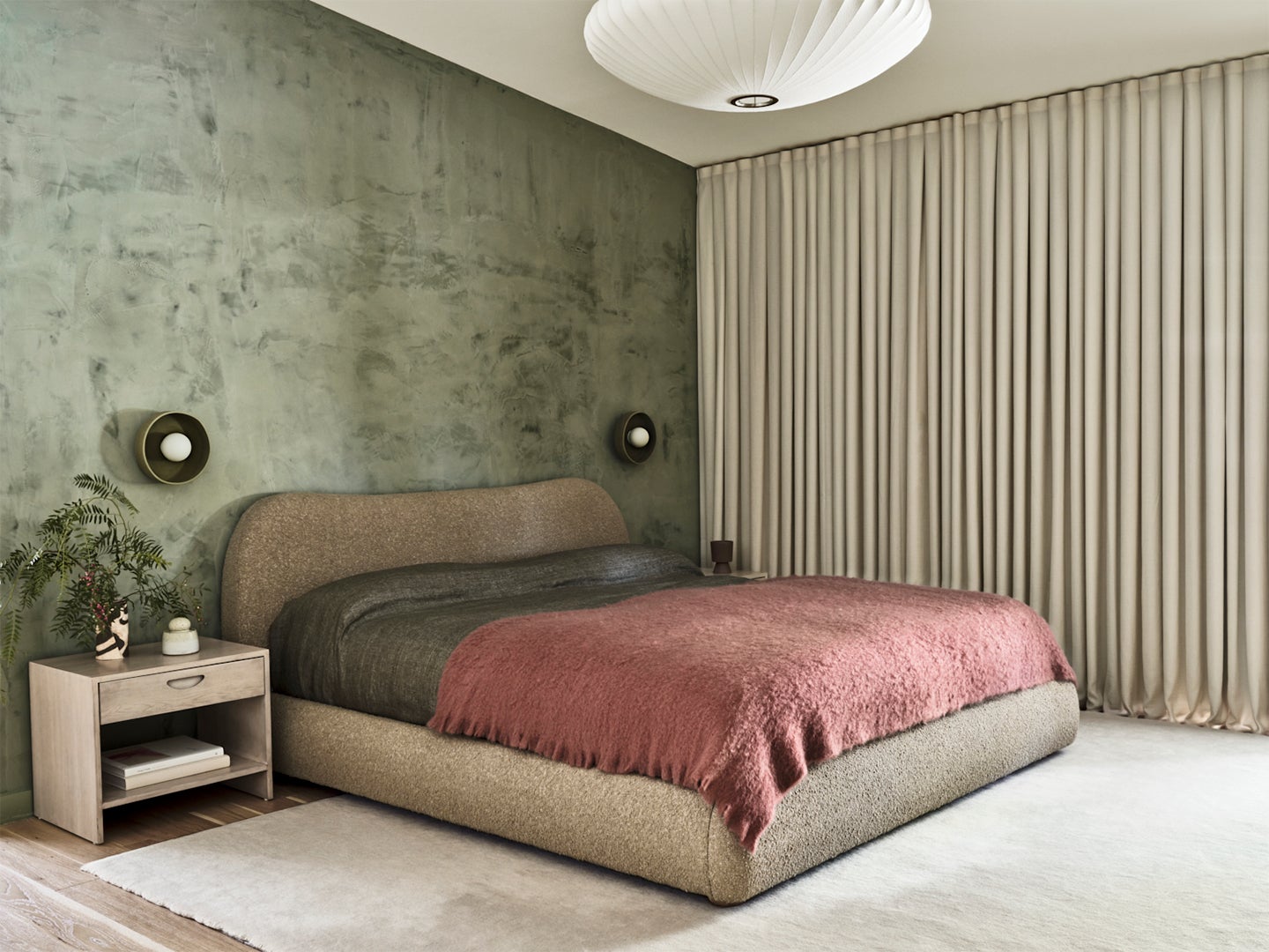 Bedroom with green walls and berry-coloured furnishings