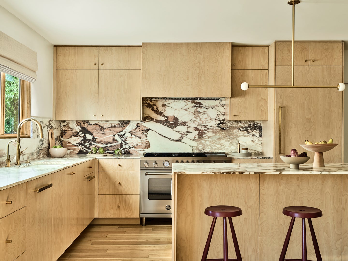 Kitchen with purple veined marble and light wood cabinets