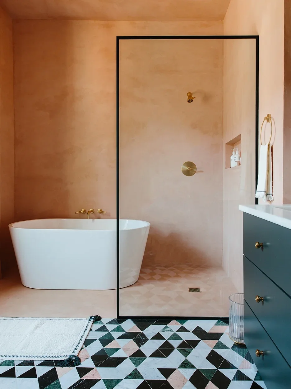 peach bathroom with tub in shower