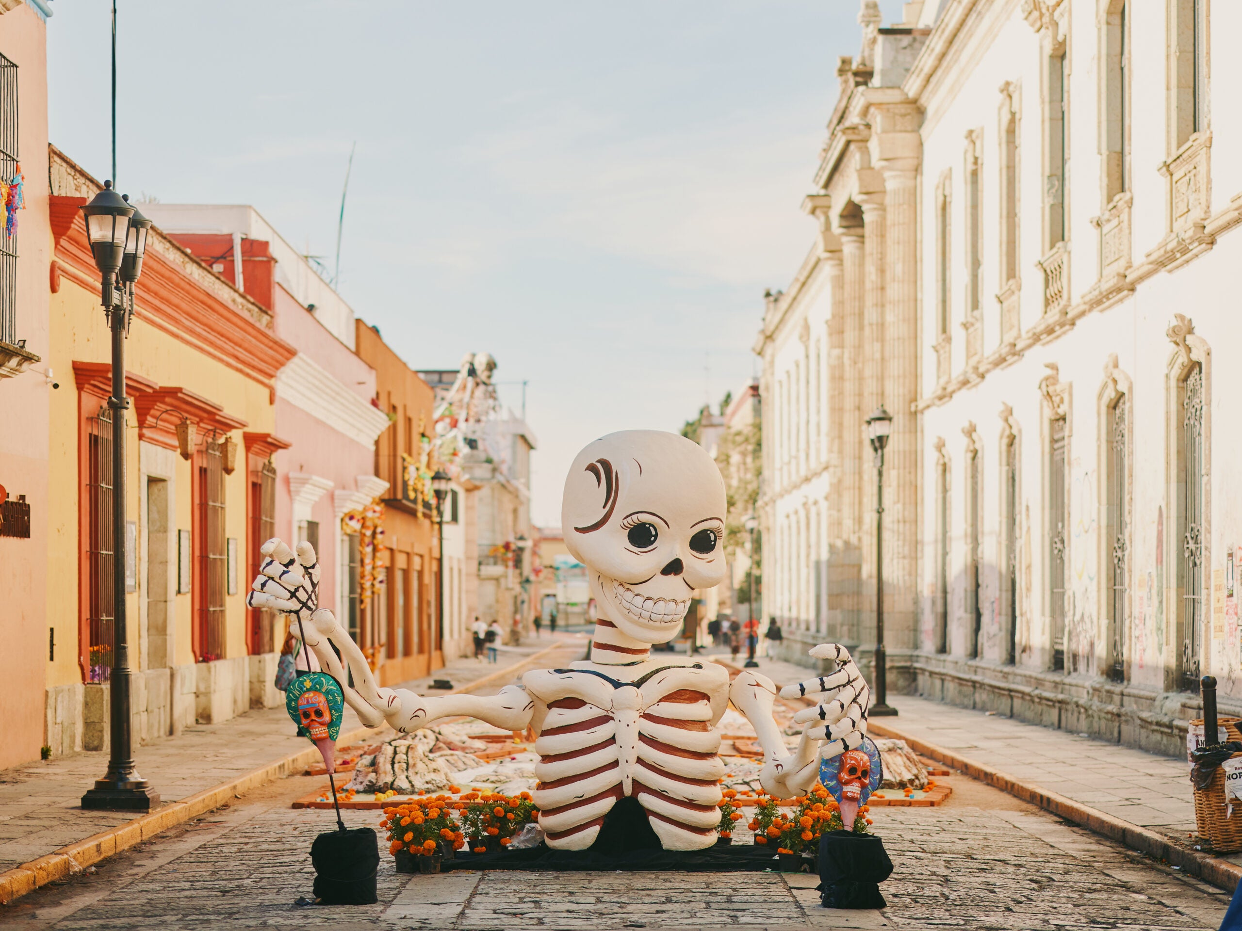 Giant skeleton popping out of cobblestone street for Day of the Dead in Oaxaca, Mexico.