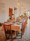 Table set up at Hacienda Guadalupe with tiled floor and wood chairs.