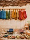 Colorful dyed yarns hanging to dry against plaster wall in TeotitlÃ¡n del Valle, Mexico.