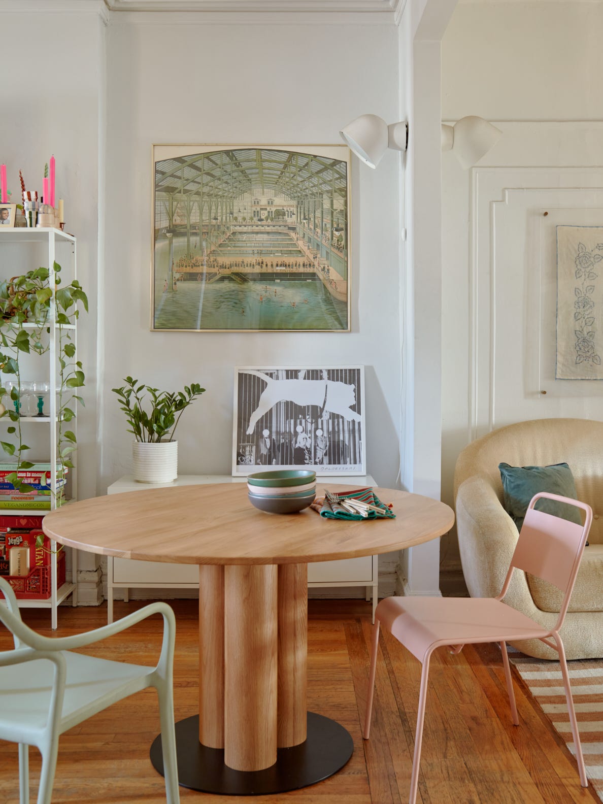 Dining room with wooden pedestal table and pink chair