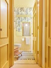 yellow wallpapered bathroom