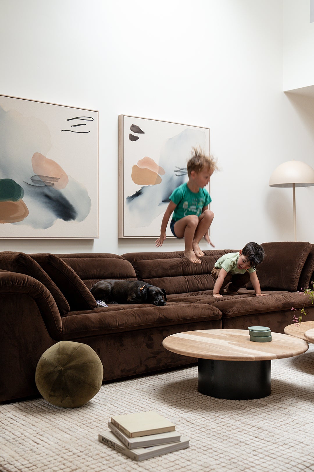 kids jumping on brown sofa