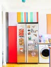 stripes of colorful cabinets above a fridge
