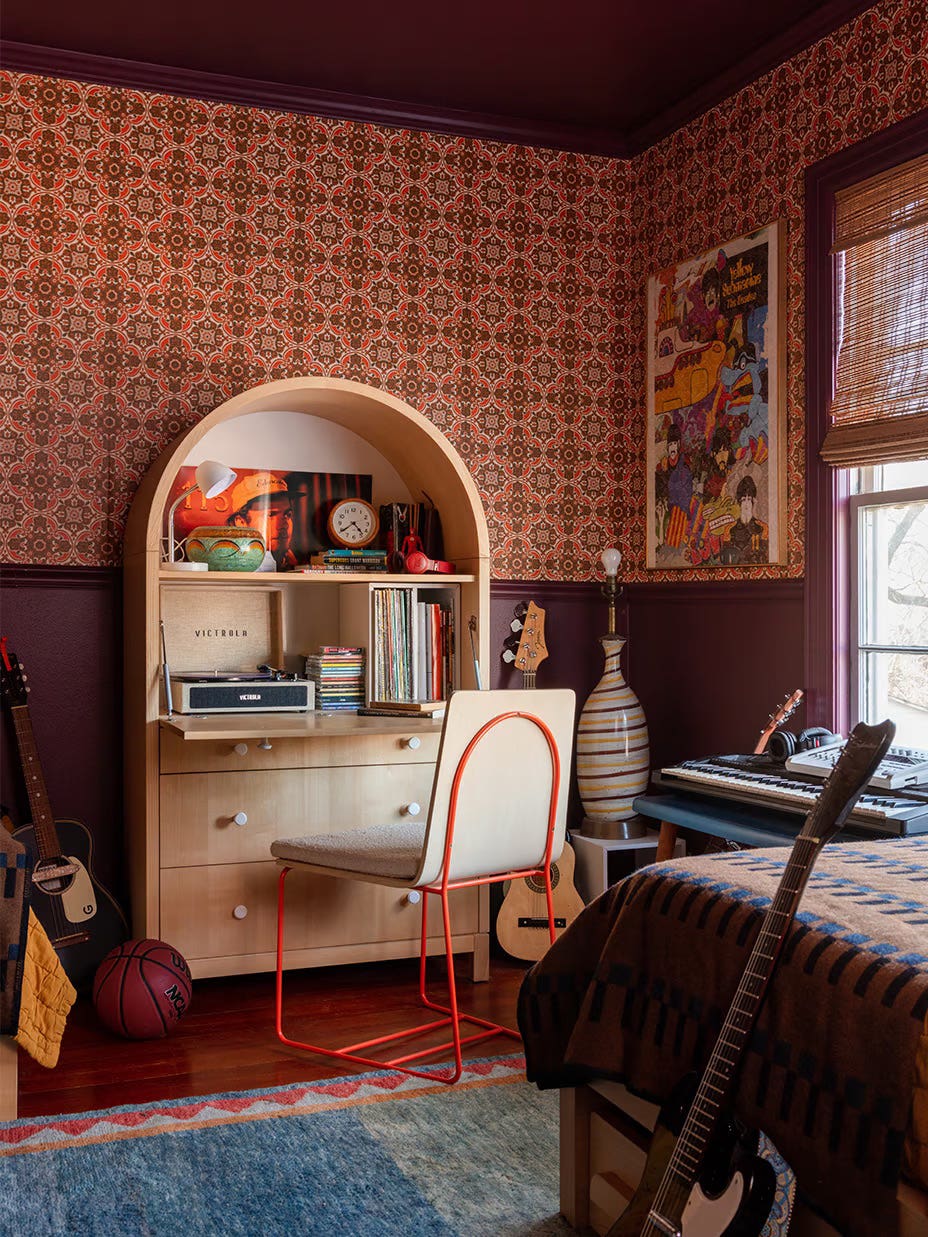 Teen bedroom with arched desk and 60s-inspired wallpaper.