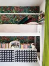 Teen room with bunk beds and jungle-print wallpaper.