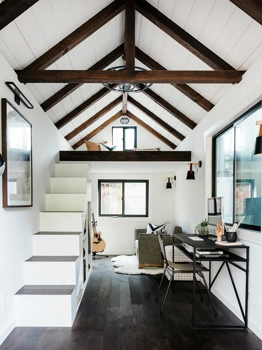 Teen bunk house with lofted wood ceilings and white walls. 
