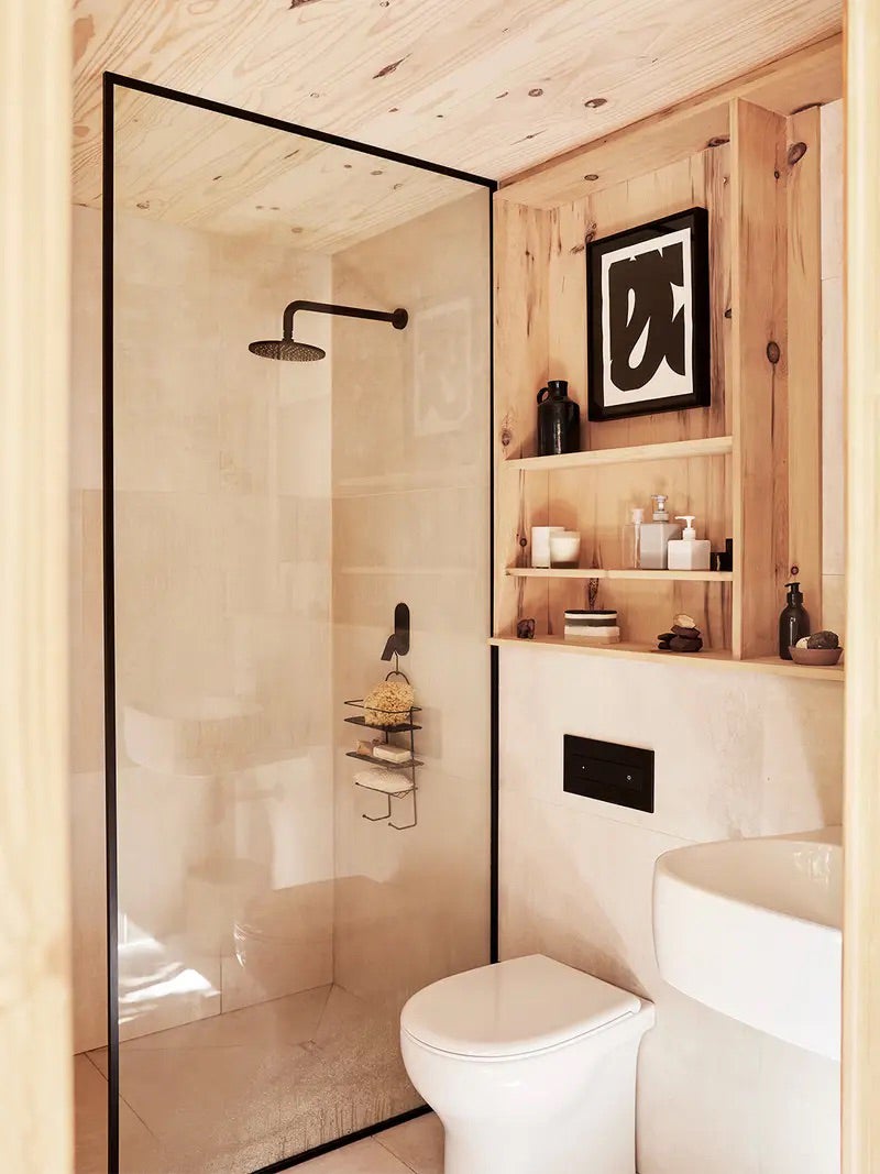 Bathroom that's pine wood-lined with shower. 