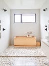 Bathroom with wood Japanese soaker tub and terrazzo tile. 