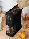 coffee maker with full beans being poured in