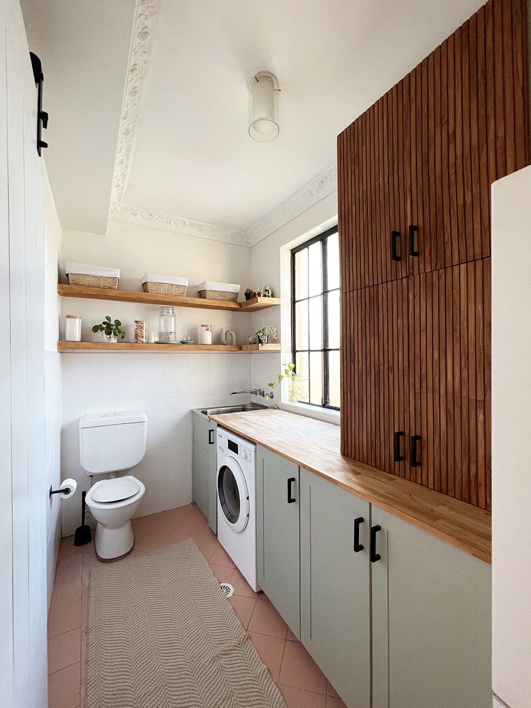 laundry room with green and wood cabinets