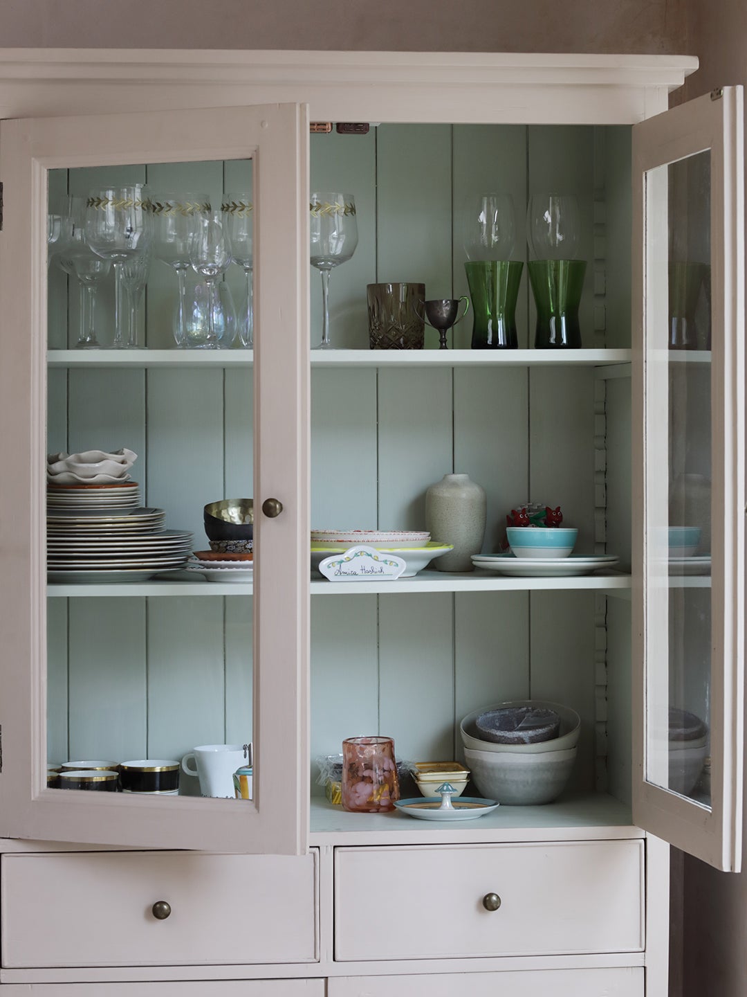 pink cabinet with blue shelves