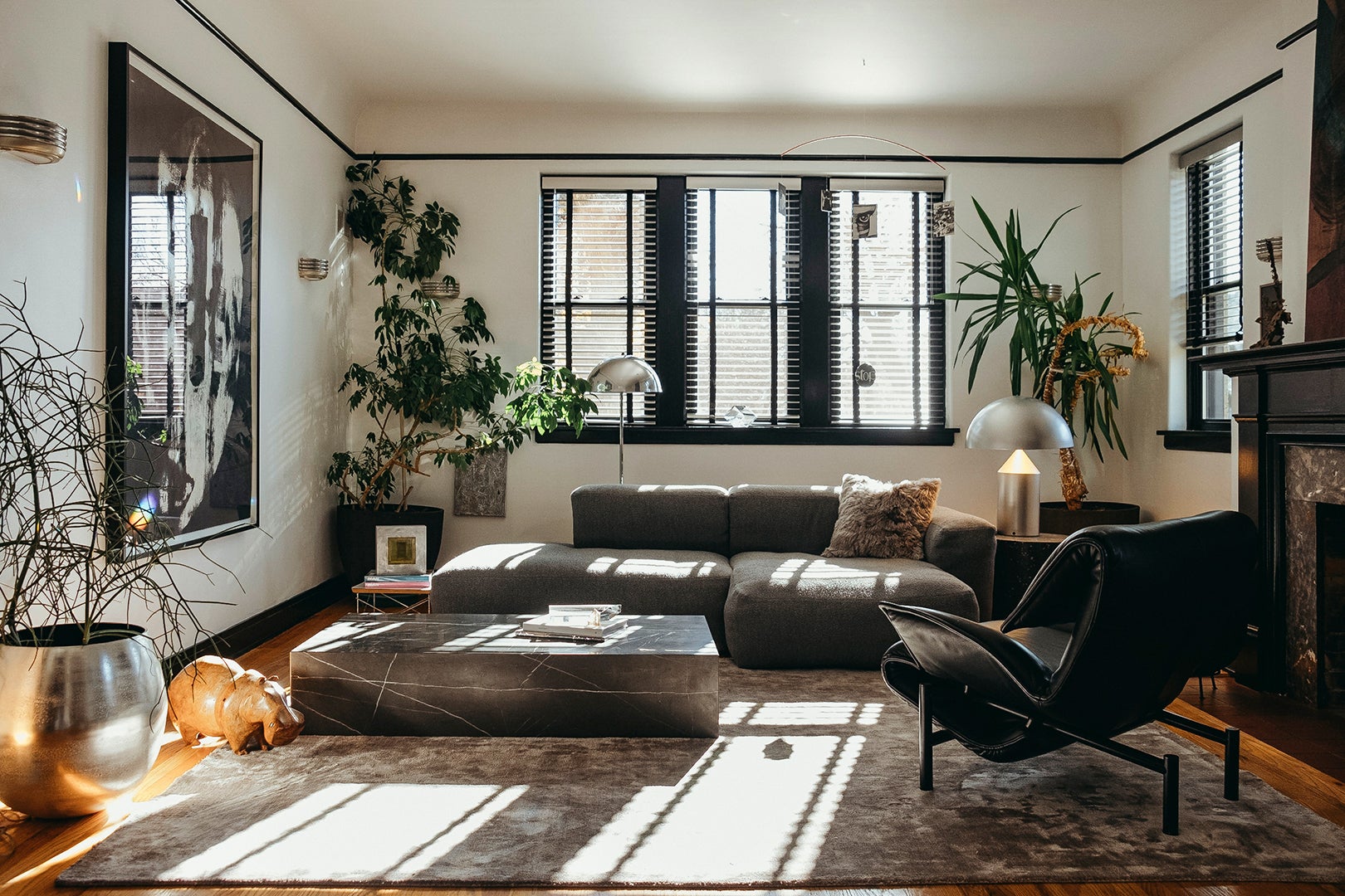 Living room with black sofa and big window