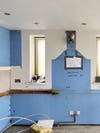 empty kitchen with blue walls mapped out