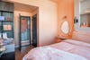 Peach hotel room with peach bedding
