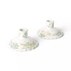 set of white floral candlestick holders