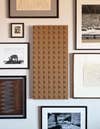 Gallery wall with leather art work featuring concentric squares.