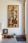 Wood with mirror fragments as art work hanging in hallway.