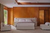 white bed in a wood paneled room