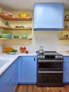 Stove and periwinkle blue range hood to match the cabinets