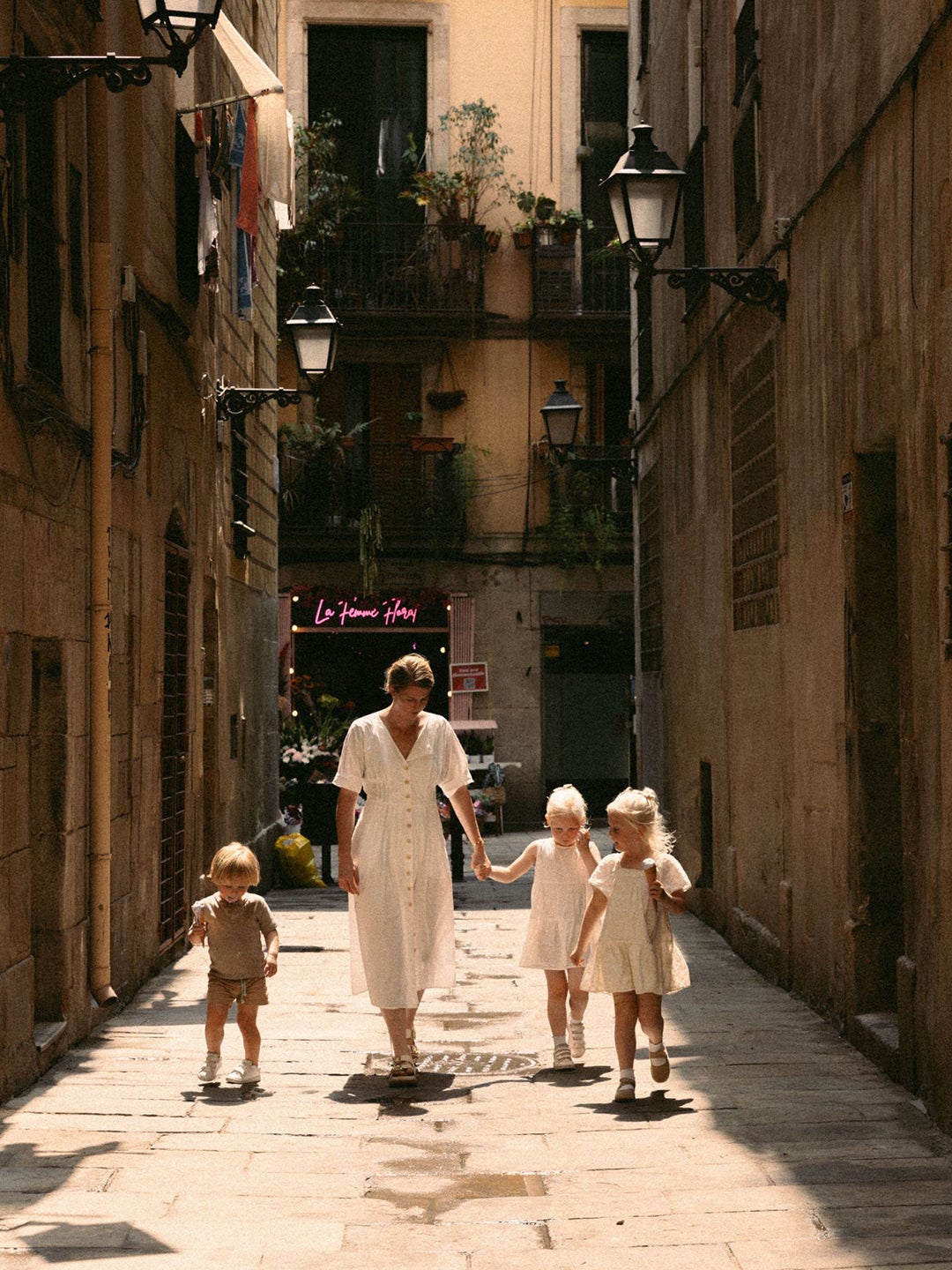 woman and kids walking on street