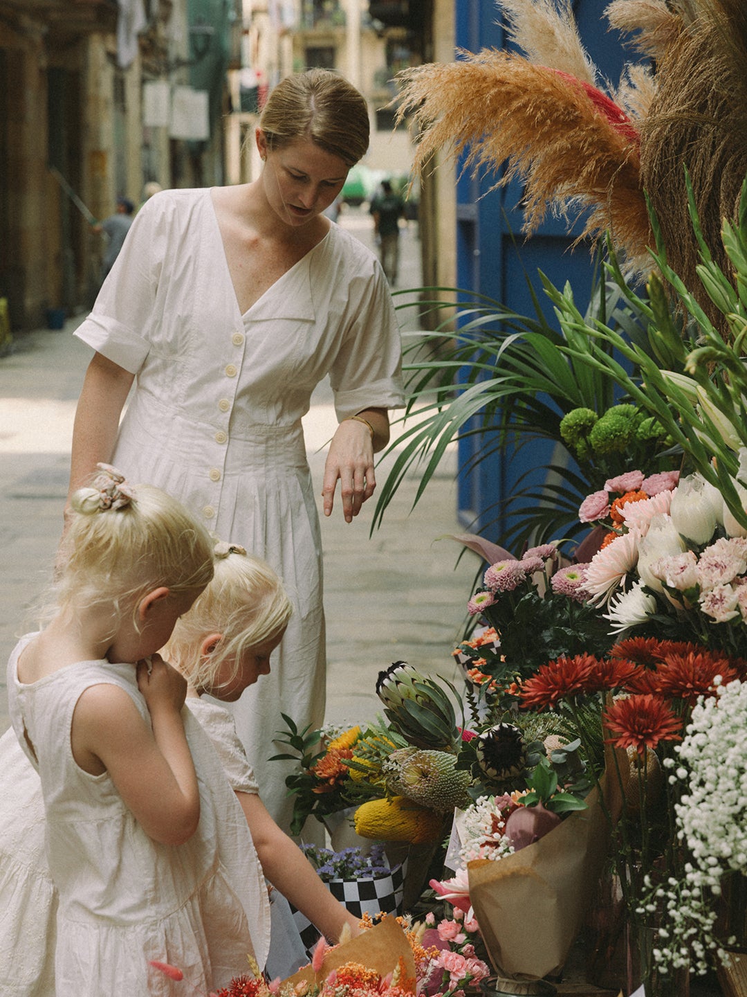 mom helping kid pick out flowers